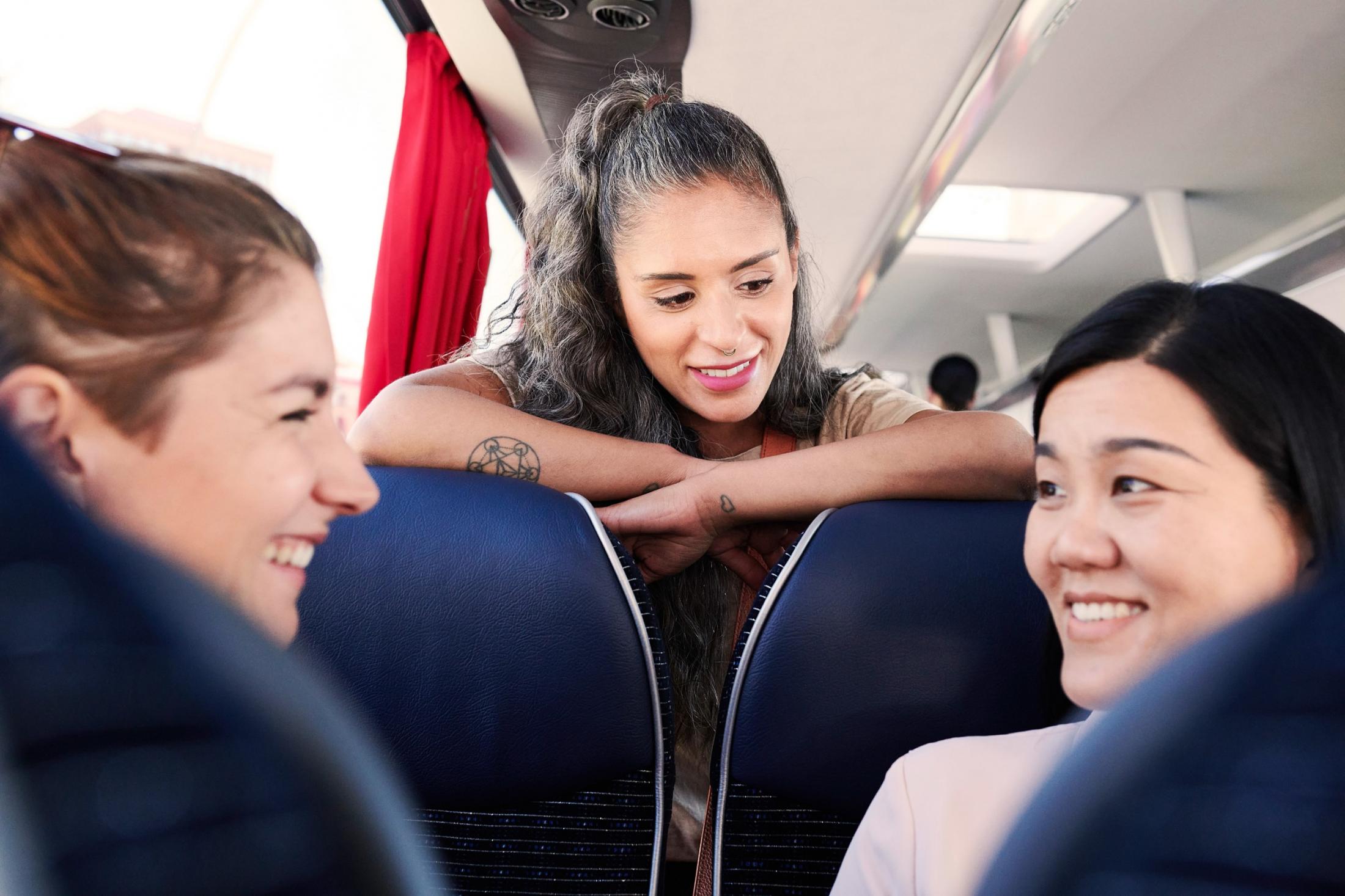 Young people chatting on a touring bus